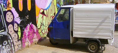 Parked Triporter in Barcelona in front of painted wall